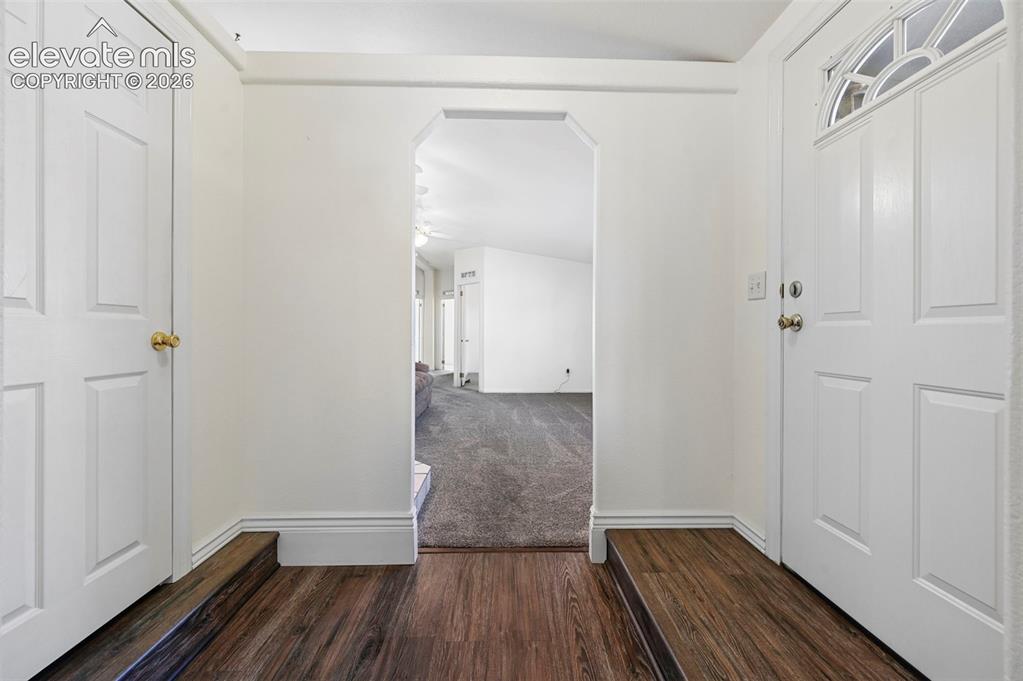 Image 24 of 50: Entryway featuring wood-finish flooring, a white exterior door with an arch