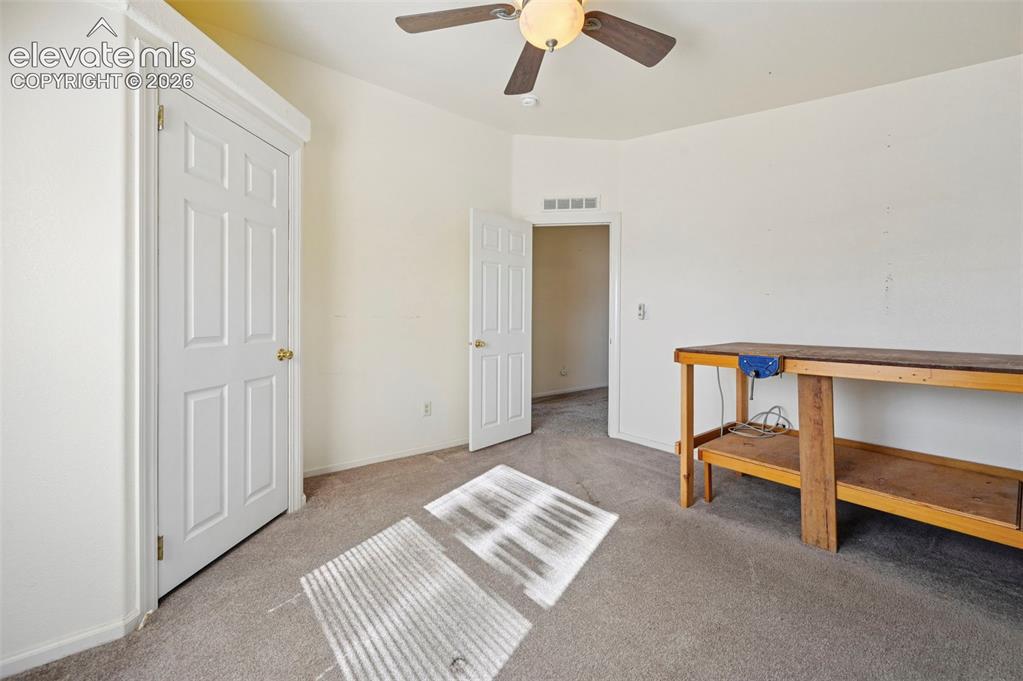 Image 33 of 50: Neutral-toned interior space featuring wall-to-wall carpeting, a ceiling-mo