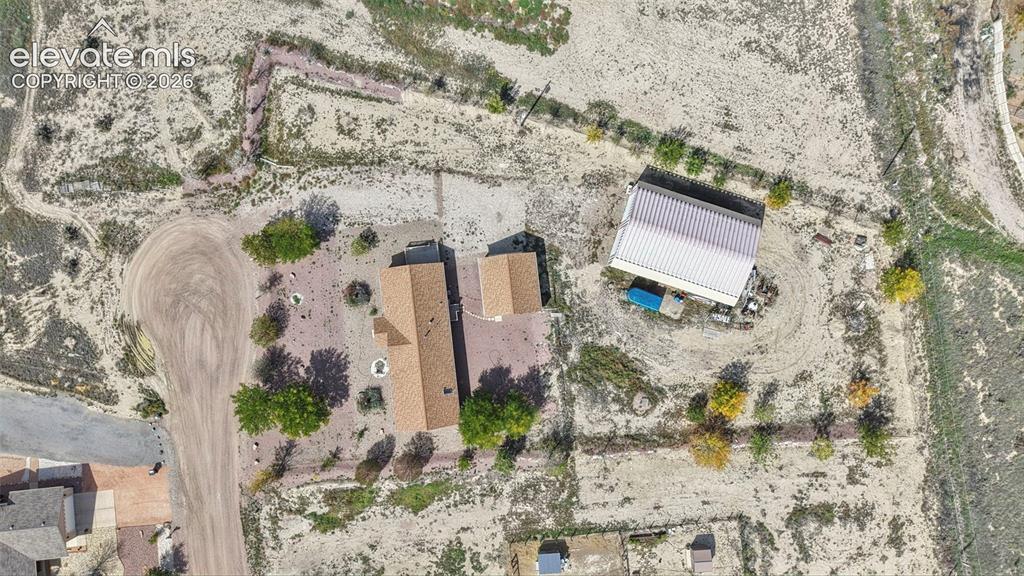 Image 43 of 50: Aerial view of a sprawling property featuring a primary residence with a sh
