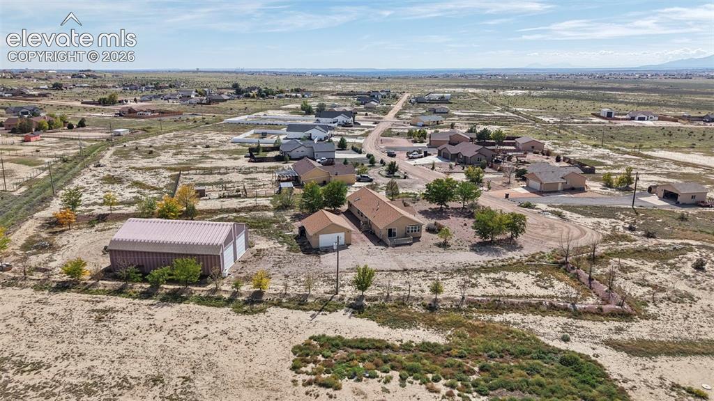 Image 47 of 50: Aerial perspective of a multi-structure property featuring a detached metal