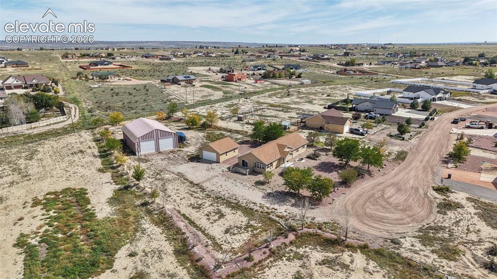 Image 48 of 50: Aerial perspective featuring a single-level residence, a detached garage, a