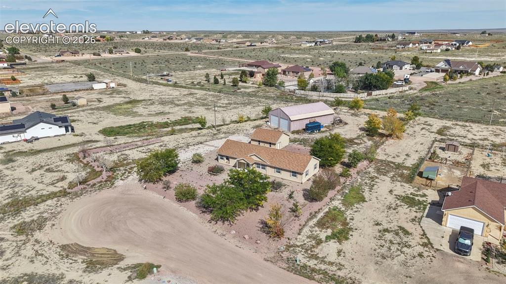 Image 50 of 50: Aerial perspective of a detached residential property featuring a shingled 