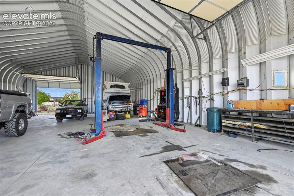 Image 7 of 50: Quonset-style structure featuring a high-clearance vaulted ceiling, industr