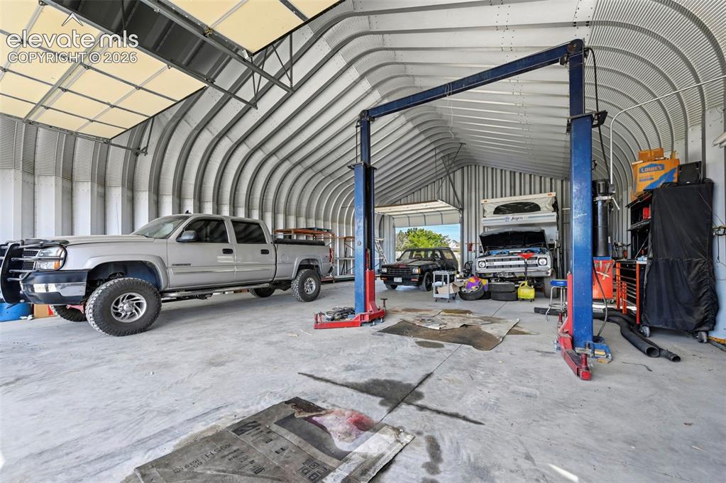 Image 8 of 50: Quonset-style structure featuring a high-clearance vaulted ceiling, corruga
