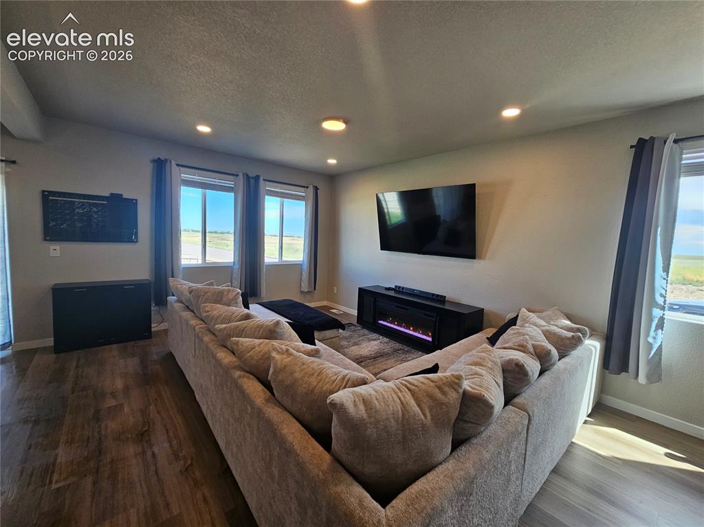 Image 10 of 35: Wood-finish flooring throughout, recessed ceiling lighting, multiple window
