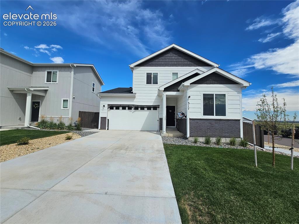 Image 3 of 35: Contemporary exterior featuring white siding, dark brick, and a single-car