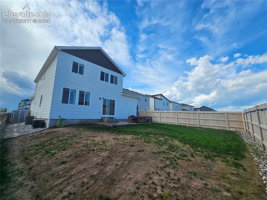 Image 34 of 35: White siding exterior with a dark-pitched roof