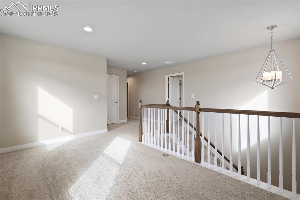 Image 18 of 25: Carpeted loft with recessed lighting 