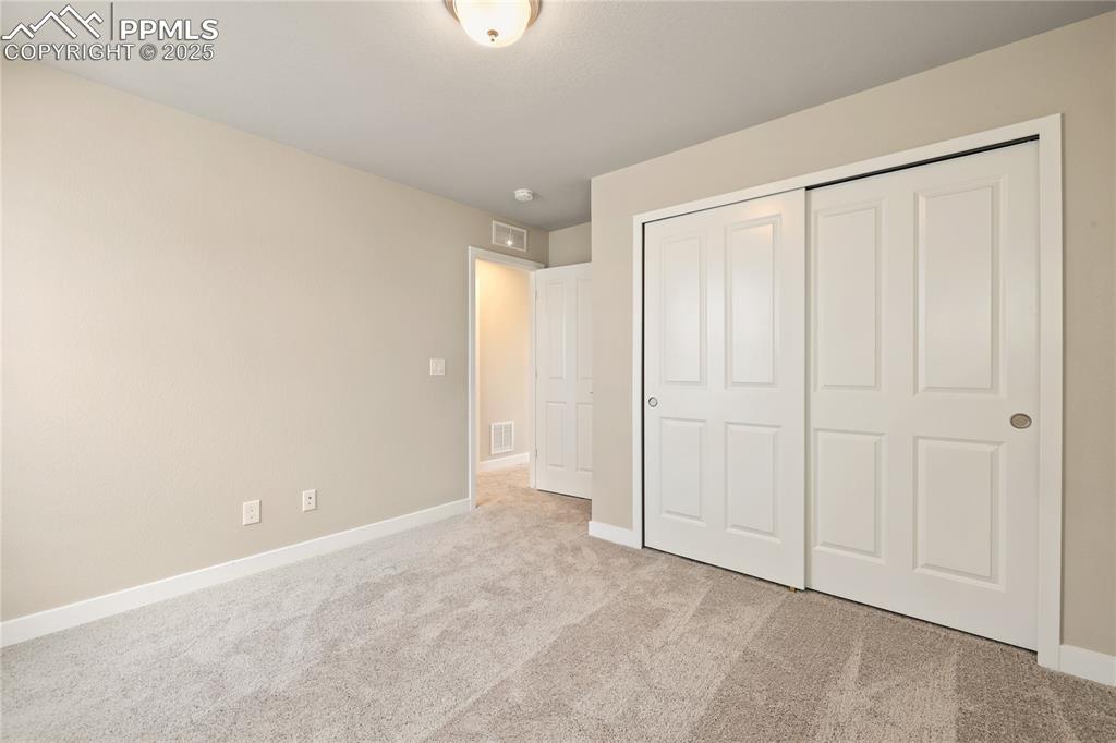Image 21 of 25: Unfurnished bedroom featuring carpet flooring and a closet