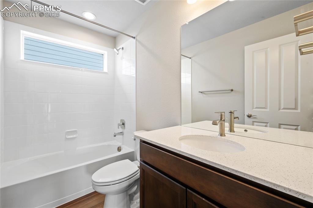 Image 22 of 25: Bathroom with shower / washtub combination, and vanity