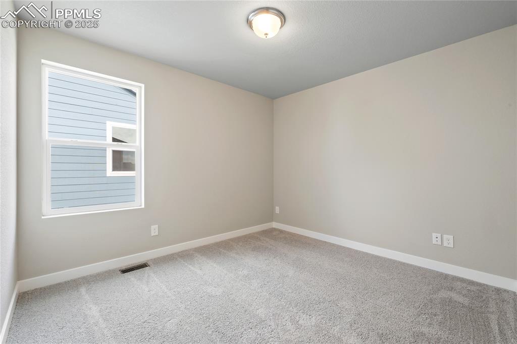 Image 23 of 25: Unfurnished room with light colored carpet and baseboards