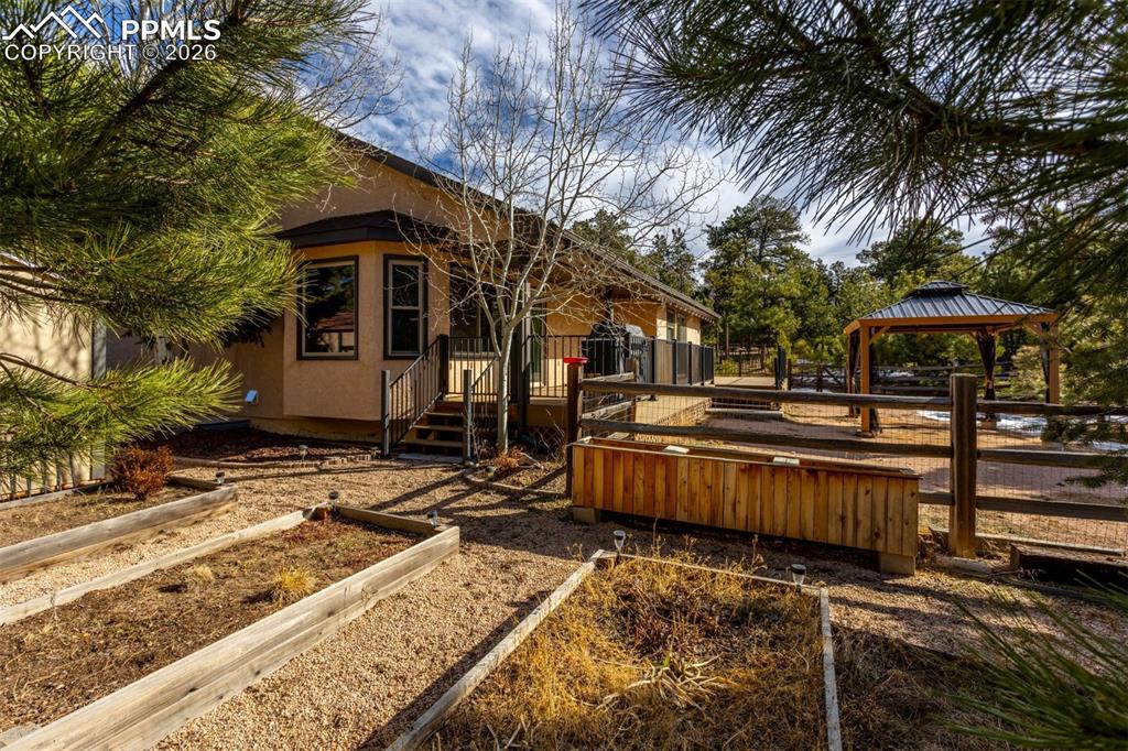 Image 10 of 50: Raised garden beds, gazebo stays