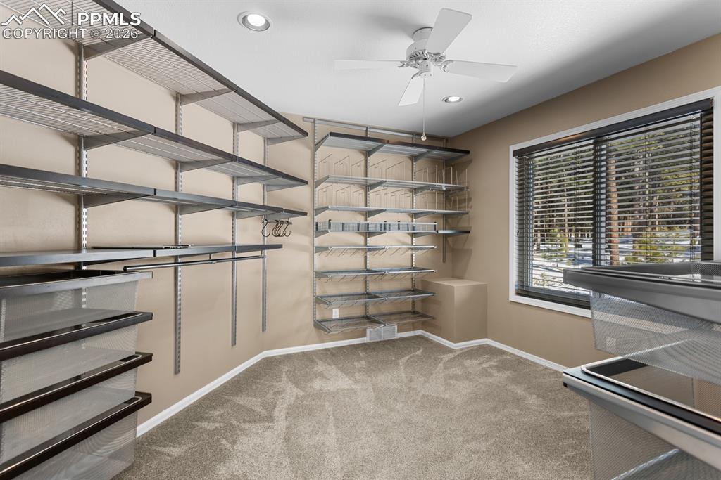 Image 26 of 50: Primary bedroom walk-in closet.  1 of 2 closets