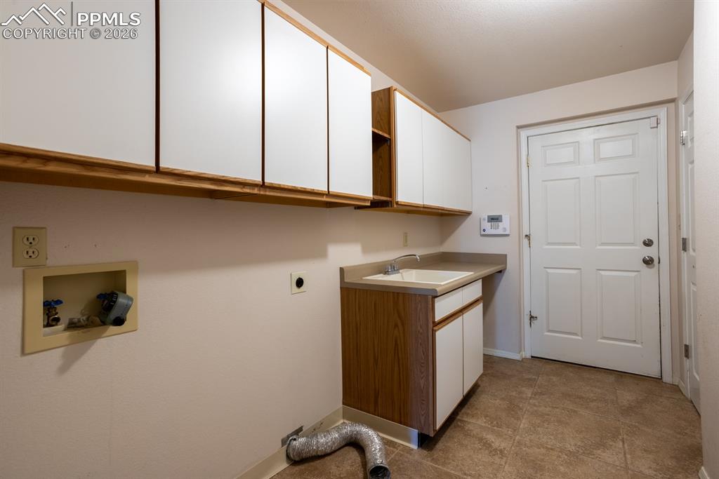 Image 32 of 50: Main level laundry with door to garage