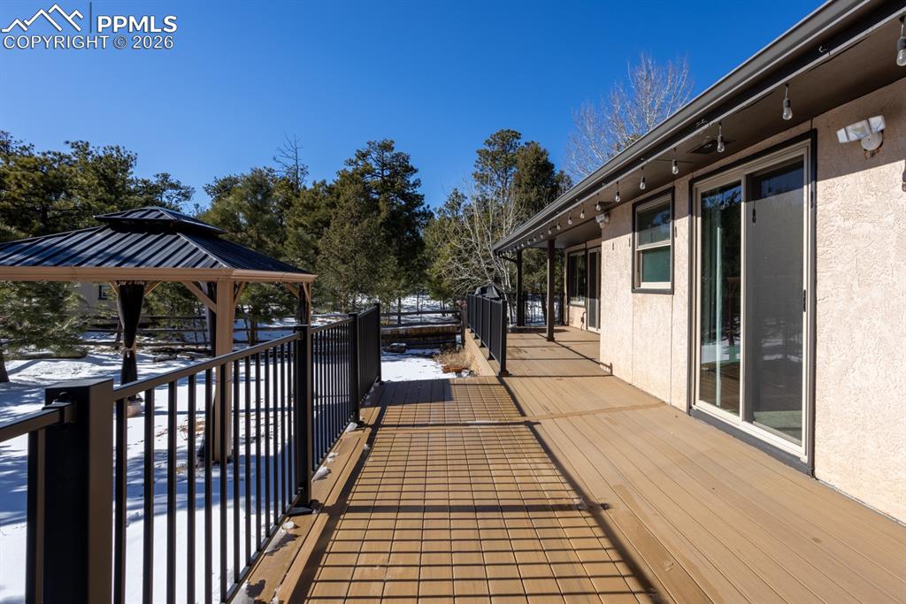 Image 49 of 50: large decking spans the back of the home!