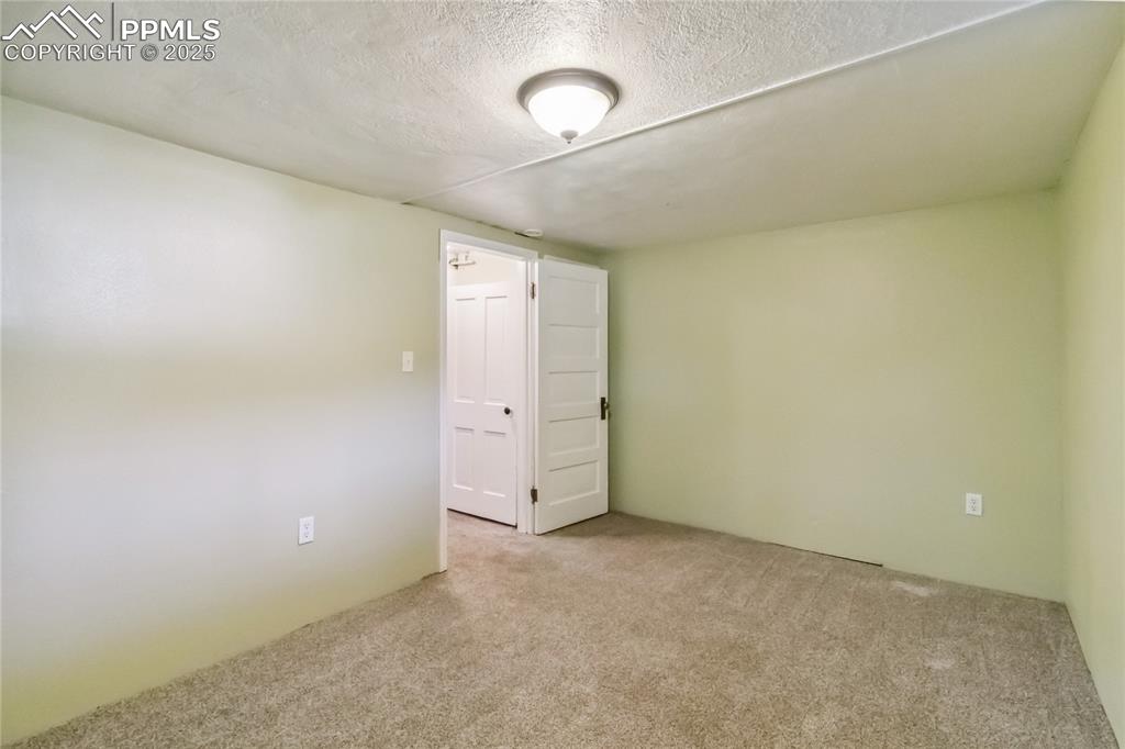 Image 24 of 49: Third bedroom in basement
