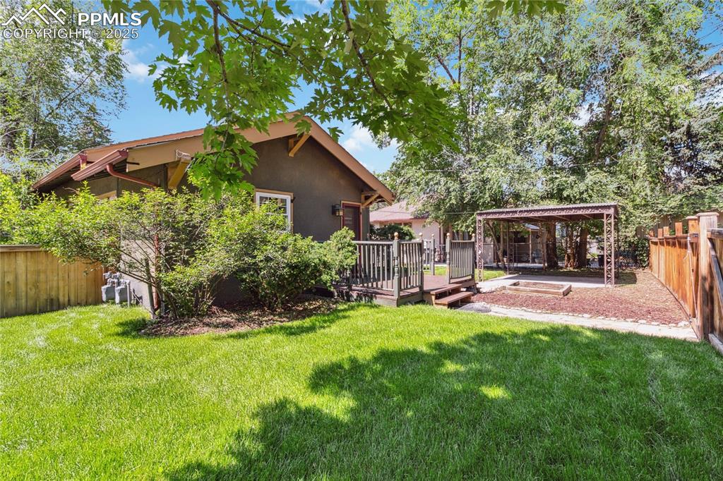 Image 26 of 49: Backyard with patio, pergola, and deck