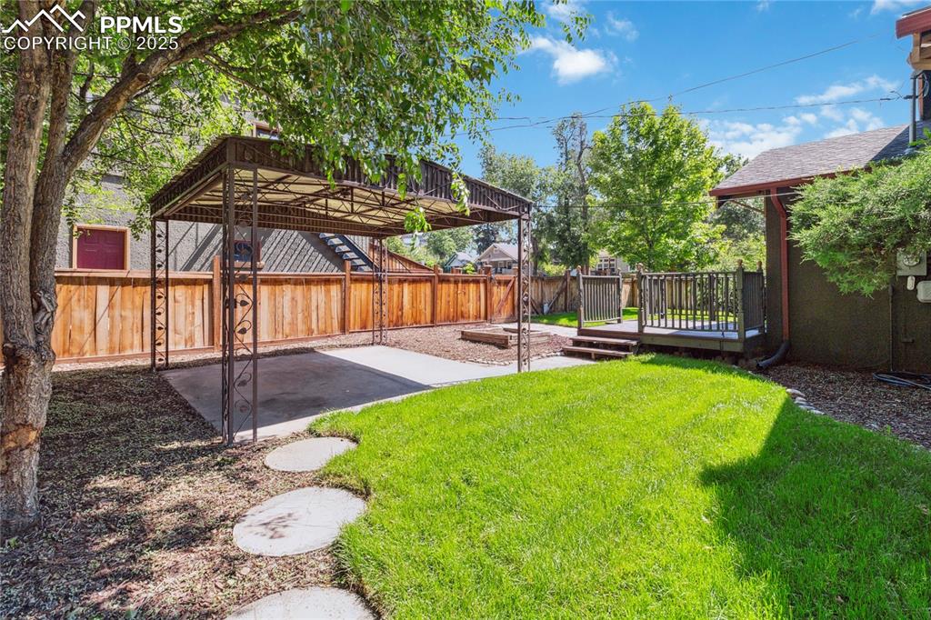 Image 27 of 49: Backyard with patio, pergola, and deck