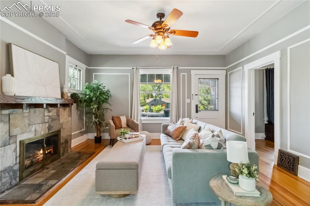 Image 3 of 49: Open-concept living with original hardwood floors