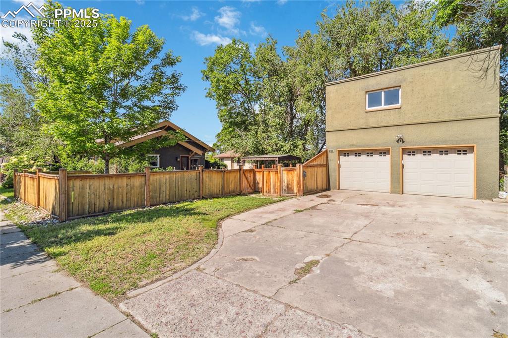 Image 43 of 49: 2-car garage with extended driveway