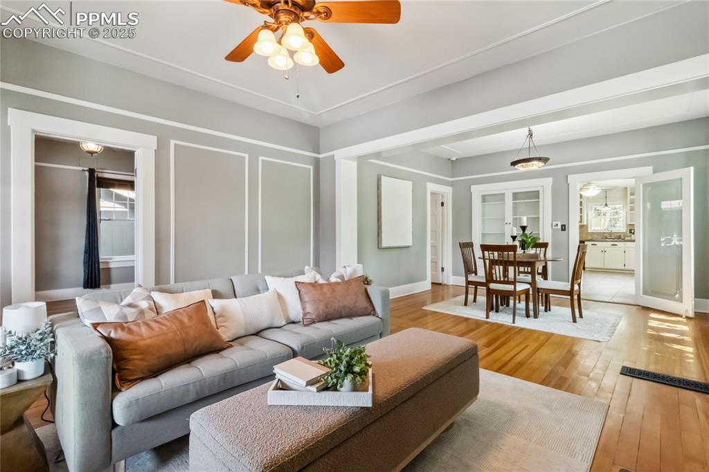 Image 5 of 49: Bright, inviting living room extends through dining room