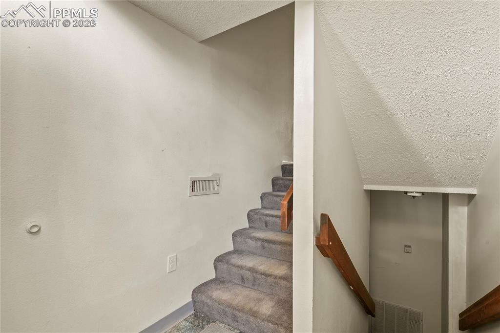 Image 28 of 31: Front entry. Stairs to garage and main level