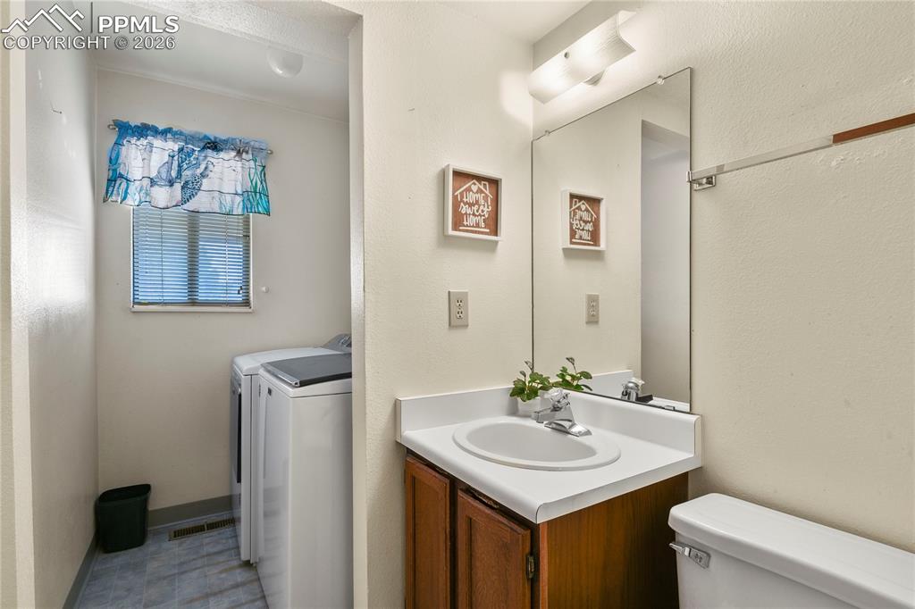 Image 9 of 31: Main Level Guest Bathroom with Laundry 