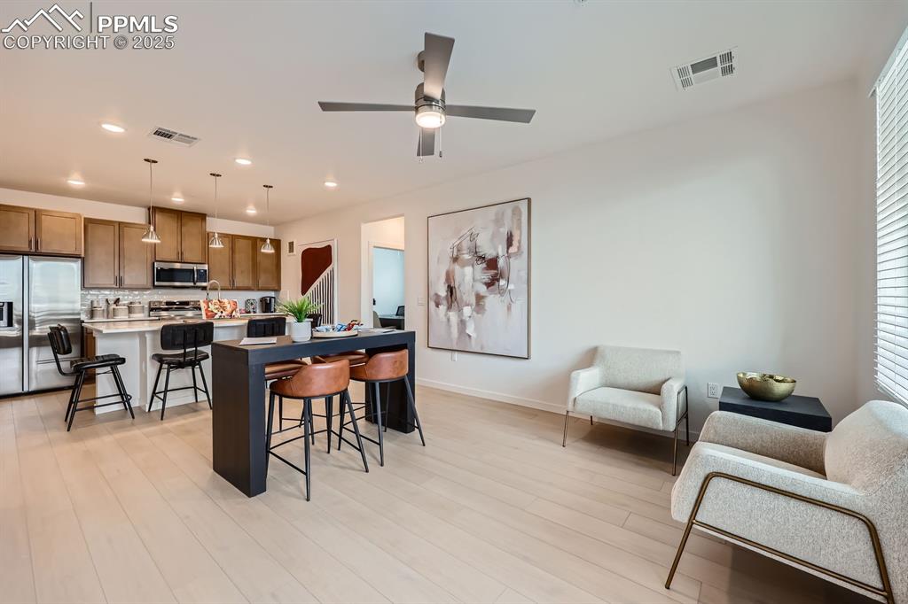 Image 2 of 9: Kitchen with stainless steel appliances, a breakfast bar area, a center isl