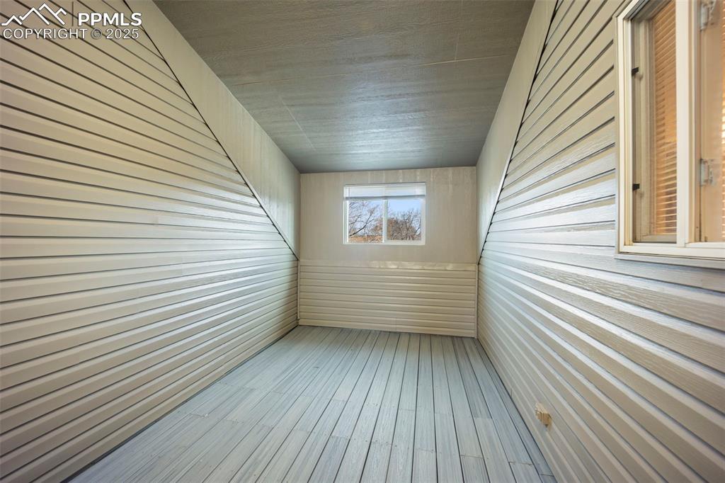 Image 22 of 40: Enclosed room off master bedroom with window and lighting