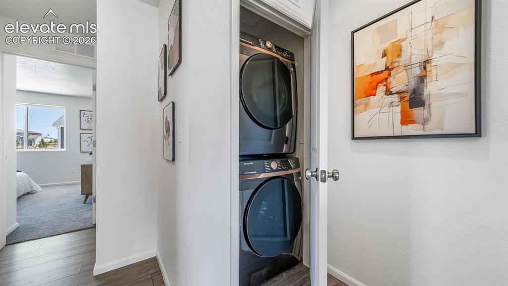 Image 12 of 26: Dedicated laundry closet featuring a stacked washer and dryer unit
*Photos