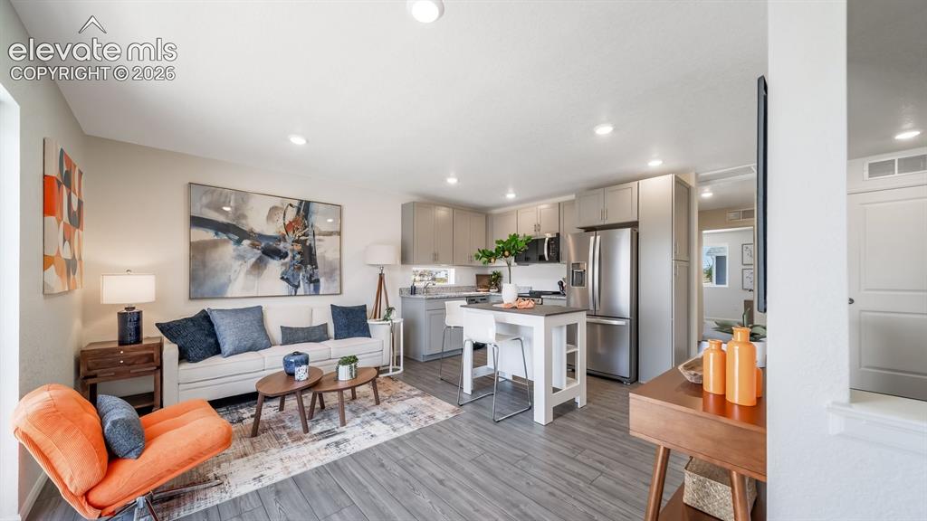 Image 17 of 26: Open-concept living area with wood-finish flooring
*Photos of a model home