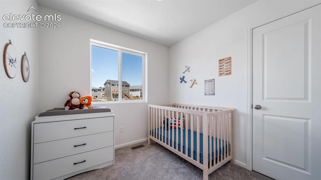 Image 7 of 26: Bright interior space featuring a window with exterior views, light gray ca