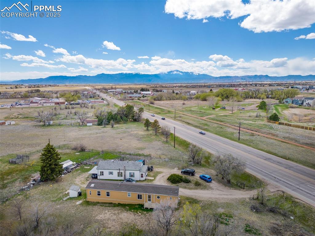 Image 4 of 7: Birds eye view of property featuring a mountain view and a rural view