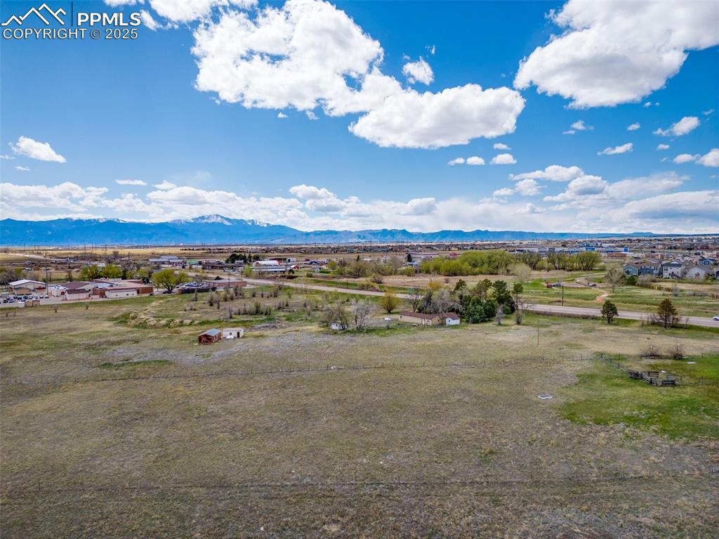 Image 7 of 7: Birds eye view of property with a rural view and a mountain view
