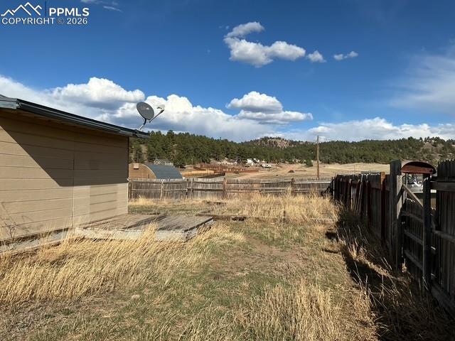 Image 11 of 36: View of fenced backyard