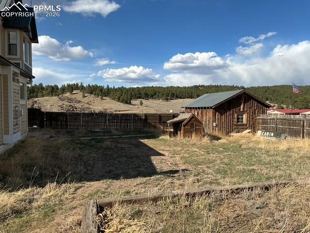 Image 12 of 36: Fenced backyard with an outbuilding and a view of rural / pastoral area