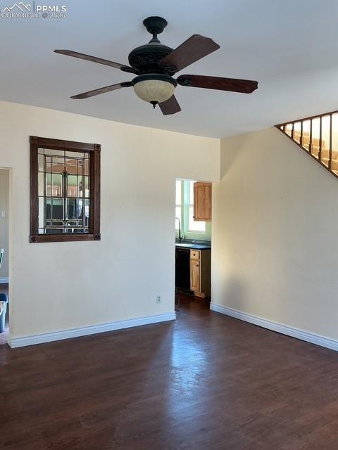 Image 16 of 36: Unfurnished living room with ceiling fan and dark wood-type flooring