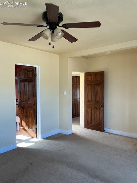 Image 28 of 36: Unfurnished room with ceiling fan and carpet