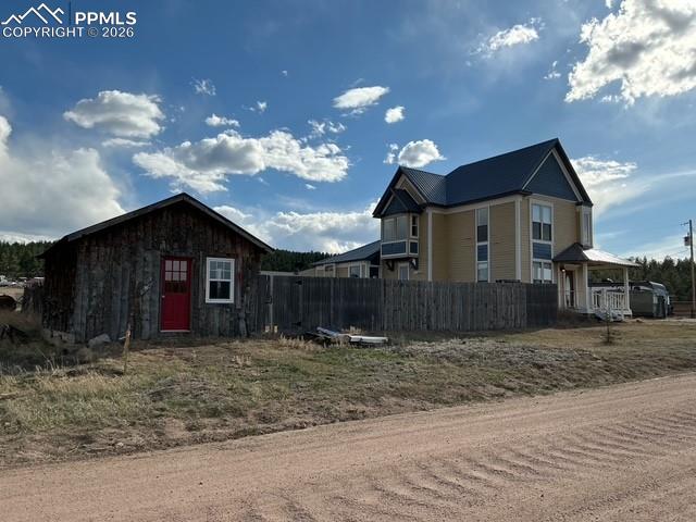 Image 4 of 36: View of front of home with an outbuilding and a metal roof