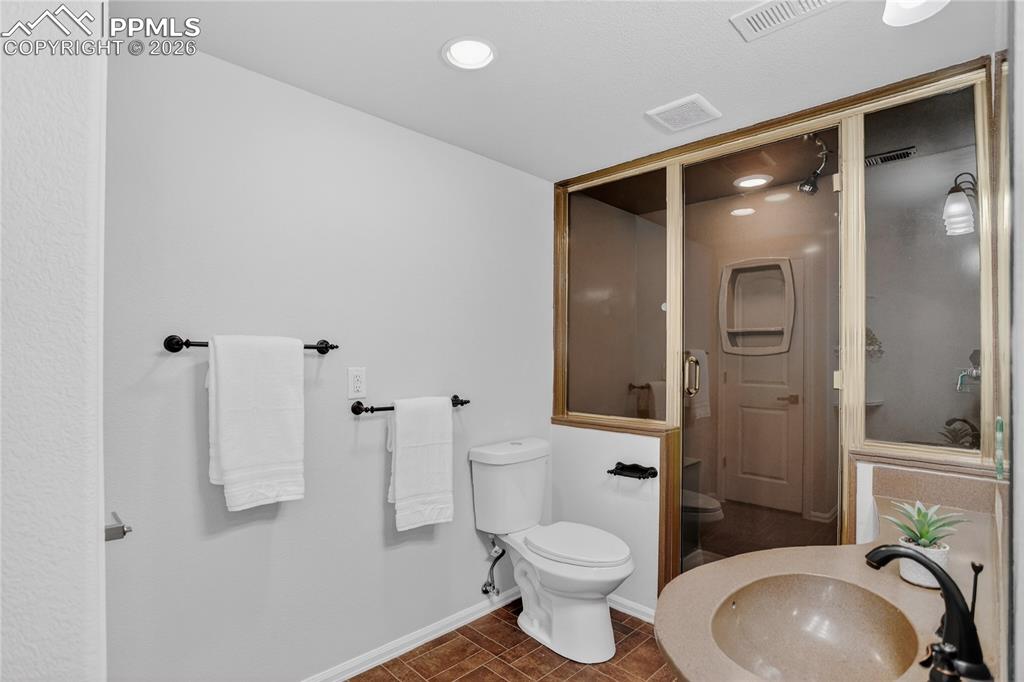 Image 23 of 29: Secondary suite bath w/ steam shower