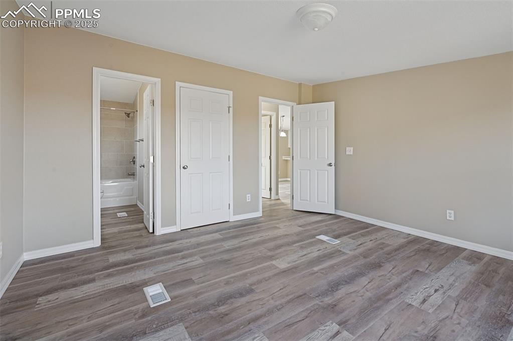 Image 25 of 33: Unfurnished bedroom featuring a closet and wood finished floors