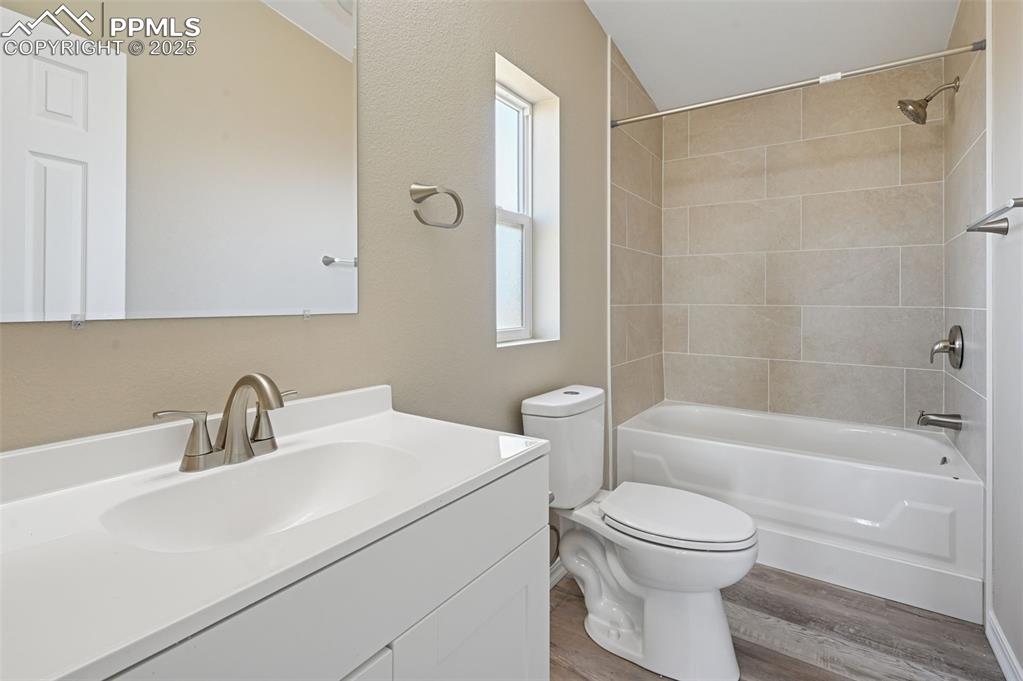 Image 26 of 33: Bathroom with vanity, bathtub / shower combination, light wood-type floorin