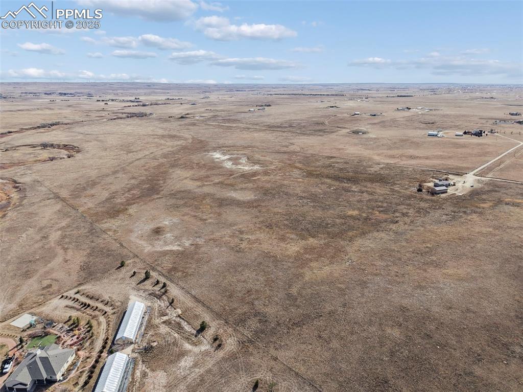 Image 33 of 33: Aerial view of sparsely populated area featuring a desert landscape