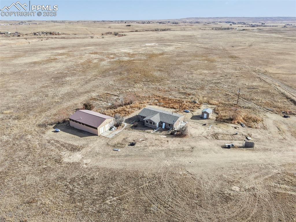 Image 6 of 33: Aerial view of sparsely populated area with a desert landscape