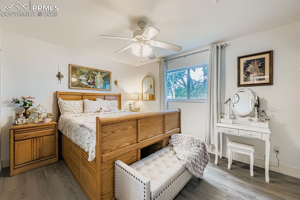 Image 19 of 27: Bedroom featuring wood finished floors and ceiling fan