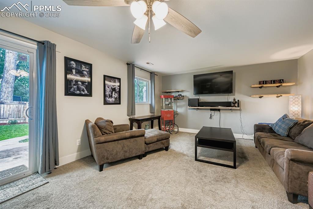 Image 22 of 27: Living area featuring carpet flooring and ceiling fan