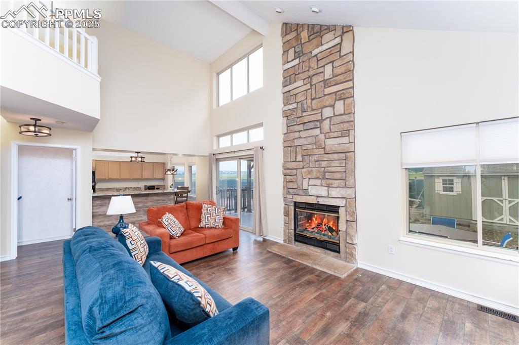 Image 5 of 34: Living room with gas fireplace and vaulted ceilings