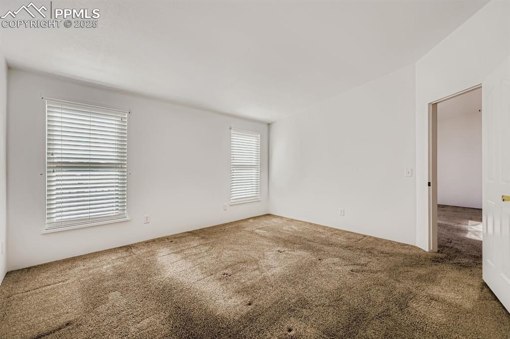 Image 17 of 29: Unfurnished room featuring carpet