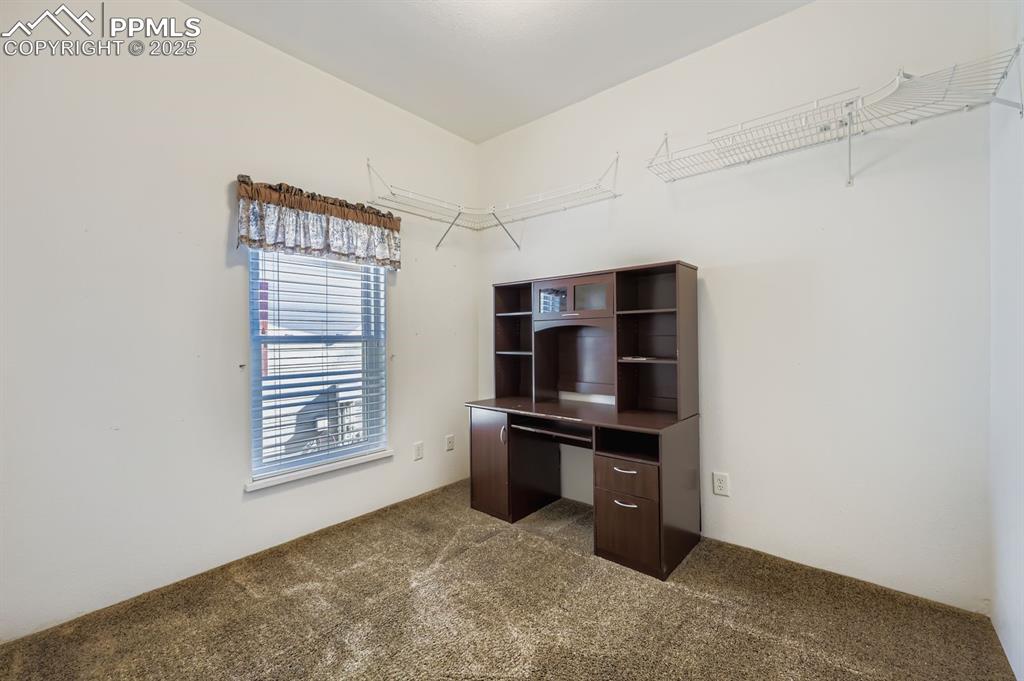 Image 21 of 29: Unfurnished office with dark colored carpet