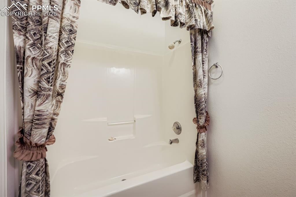 Image 26 of 29: Full bathroom with shower / bath combination with curtain